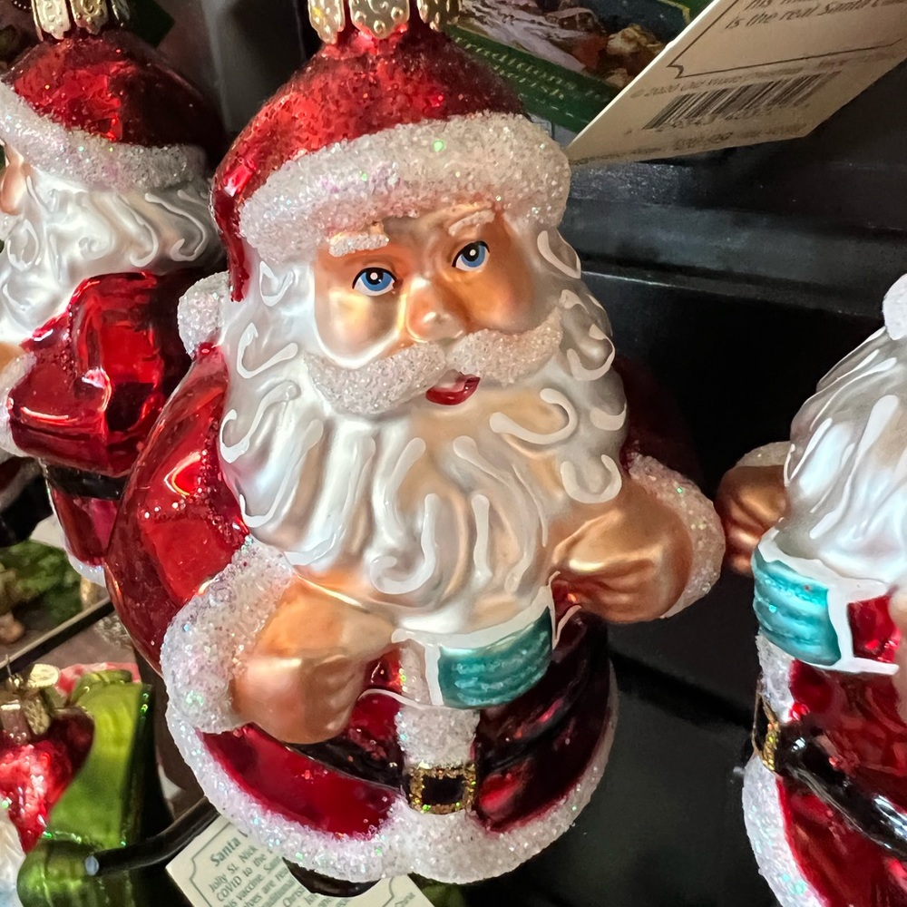 Old world Santa taking off his mask.